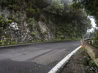 a road goes uphill to the right on a windy day in the mountainside