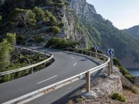 the road going down the mountain to the ocean is narrow and empty at this time of day
