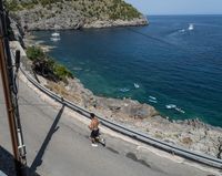 a paved road beside some large boats and a bridge with a bridge to the water