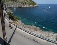 a paved road beside some large boats and a bridge with a bridge to the water