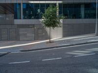 an empty street in front of a building with windows and signs on it that read one way