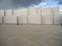 empty area outside concrete building with no people or vehicles at the entrance to area behind it