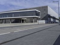 the entrance to the new state library building is shown from an angle of view, on a cobblestone walk