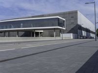 the entrance to the new state library building is shown from an angle of view, on a cobblestone walk