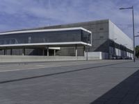 the entrance to the new state library building is shown from an angle of view, on a cobblestone walk