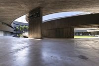 there is a circular lobby inside of an office building or school with a bench in the middle