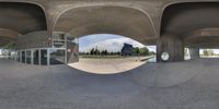 an empty building with a fish eye lens effect showing the space outside of it and it's windows