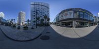 the view of the city from a fish eye lens camera, it shows several large buildings