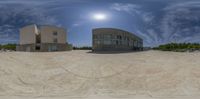 a fish eye view of some buildings on the ground with a ramp and ramp leading to it