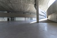 concrete building with large white circular area inside a building at the edge of a building