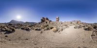 a panoramic photograph of the desert taken from a dirt road in the mountains