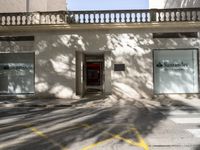 a stop sign sits in front of a building next to the curb lines on a street