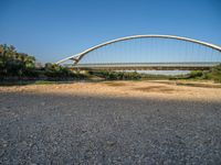 there are two very long bridges that are above the river shore at dusk here, and you can see how close them are