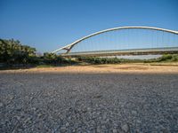 there are two very long bridges that are above the river shore at dusk here, and you can see how close them are