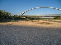 there are two very long bridges that are above the river shore at dusk here, and you can see how close them are