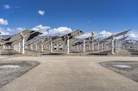 a row of solar panels on the ground of a solar park in the desert setting