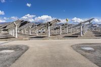 a row of solar panels on the ground of a solar park in the desert setting