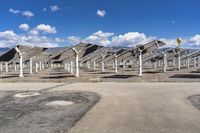 a row of solar panels on the ground of a solar park in the desert setting