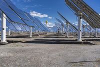 rows of solar panels in an industrial setting under a blue sky with white clouds and a large yellow balloon in the middle