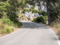 the curve of a mountain road is empty without traffic and no cars on it for some reason