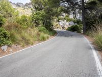 the curve of a mountain road is empty without traffic and no cars on it for some reason