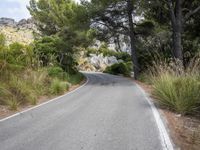 the curve of a mountain road is empty without traffic and no cars on it for some reason