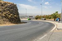 a hill with cars going down it near a road and traffic lanes with no traffic