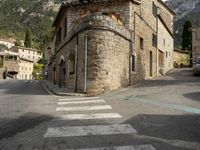 the street signs indicate the direction to go in from across the mountain range, and the steep buildings make their way