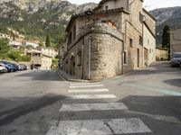 the street signs indicate the direction to go in from across the mountain range, and the steep buildings make their way