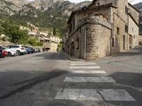 the street signs indicate the direction to go in from across the mountain range, and the steep buildings make their way