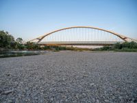 there are two very long bridges that are above the river shore at dusk here, and you can see how close them are