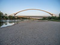 there are two very long bridges that are above the river shore at dusk here, and you can see how close them are