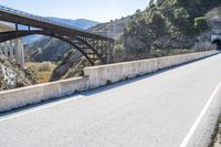 a road, with a pedestrian bridge crossing over the hill on both sides of it