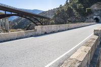 a road, with a pedestrian bridge crossing over the hill on both sides of it