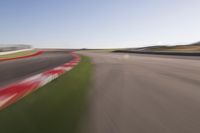 a speed motion on an empty track with a car coming toward the corner, taken from a camera