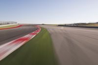 a speed motion on an empty track with a car coming toward the corner, taken from a camera