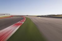 a speed motion on an empty track with a car coming toward the corner, taken from a camera