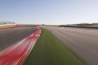 a speed motion on an empty track with a car coming toward the corner, taken from a camera