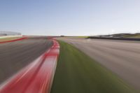 a speed motion on an empty track with a car coming toward the corner, taken from a camera