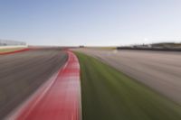 a speed motion on an empty track with a car coming toward the corner, taken from a camera