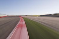 a speed motion on an empty track with a car coming toward the corner, taken from a camera