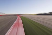 a speed motion on an empty track with a car coming toward the corner, taken from a camera