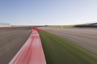 a speed motion on an empty track with a car coming toward the corner, taken from a camera