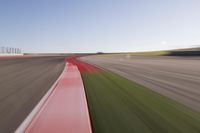 a speed motion on an empty track with a car coming toward the corner, taken from a camera