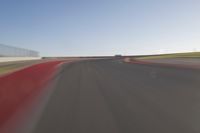 a speedboat glides across a track on an empty runway with blurry driving