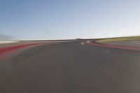 a speedboat glides across a track on an empty runway with blurry driving