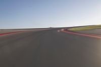 a speedboat glides across a track on an empty runway with blurry driving