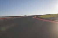 a speedboat glides across a track on an empty runway with blurry driving