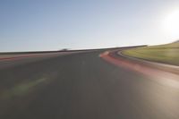 a speedboat glides across a track on an empty runway with blurry driving