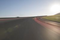 a speedboat glides across a track on an empty runway with blurry driving